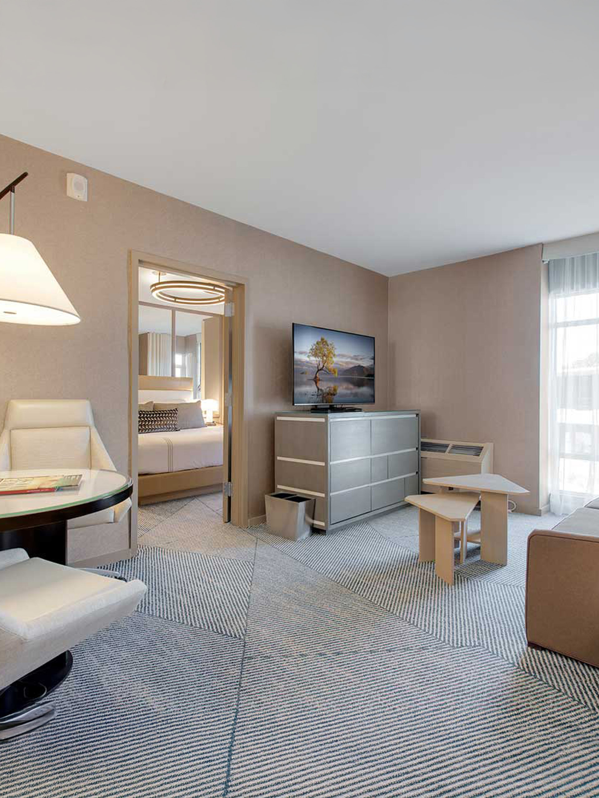Suite living area with desk and sofa.