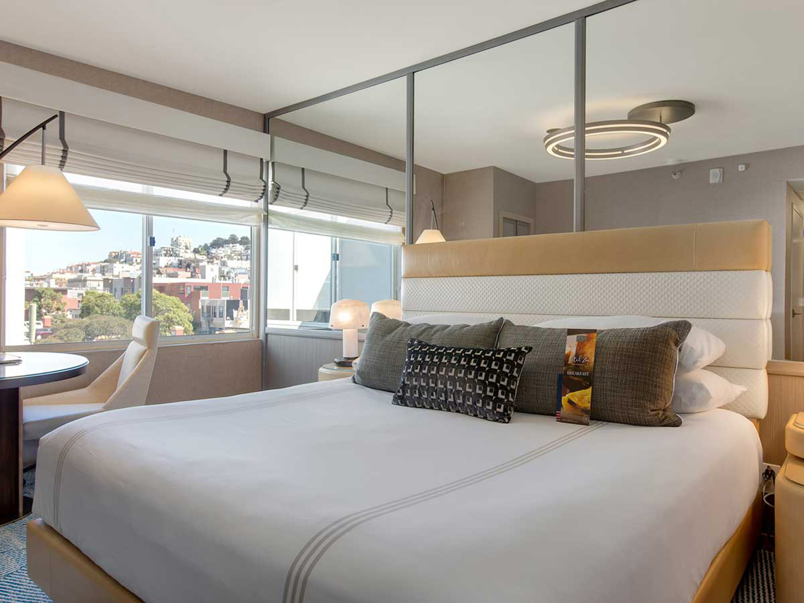 Deluxe King room with large bed and city view.