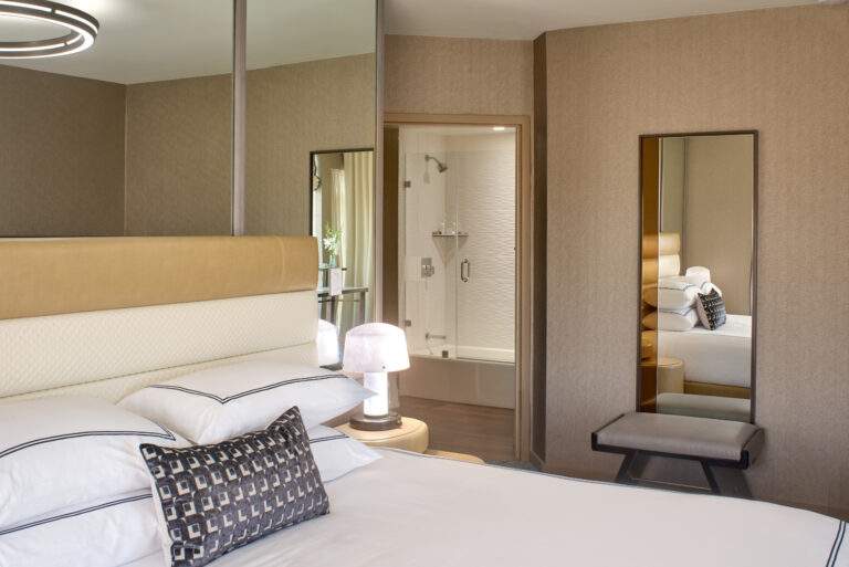 Bedroom view toward bathroom with modern decor.