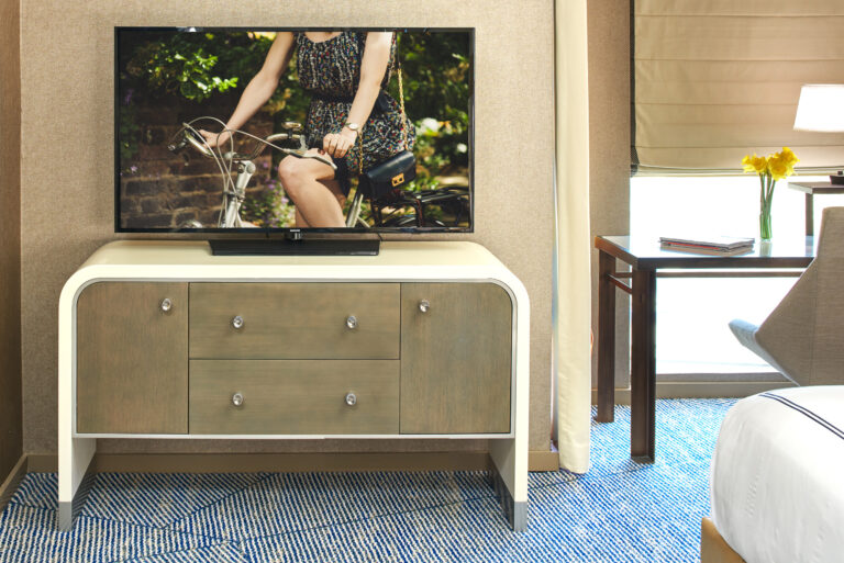 Close-up of TV on wooden dresser.