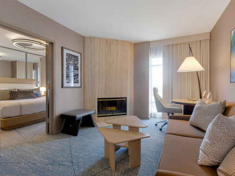 Suite living area with fireplace and workspace.