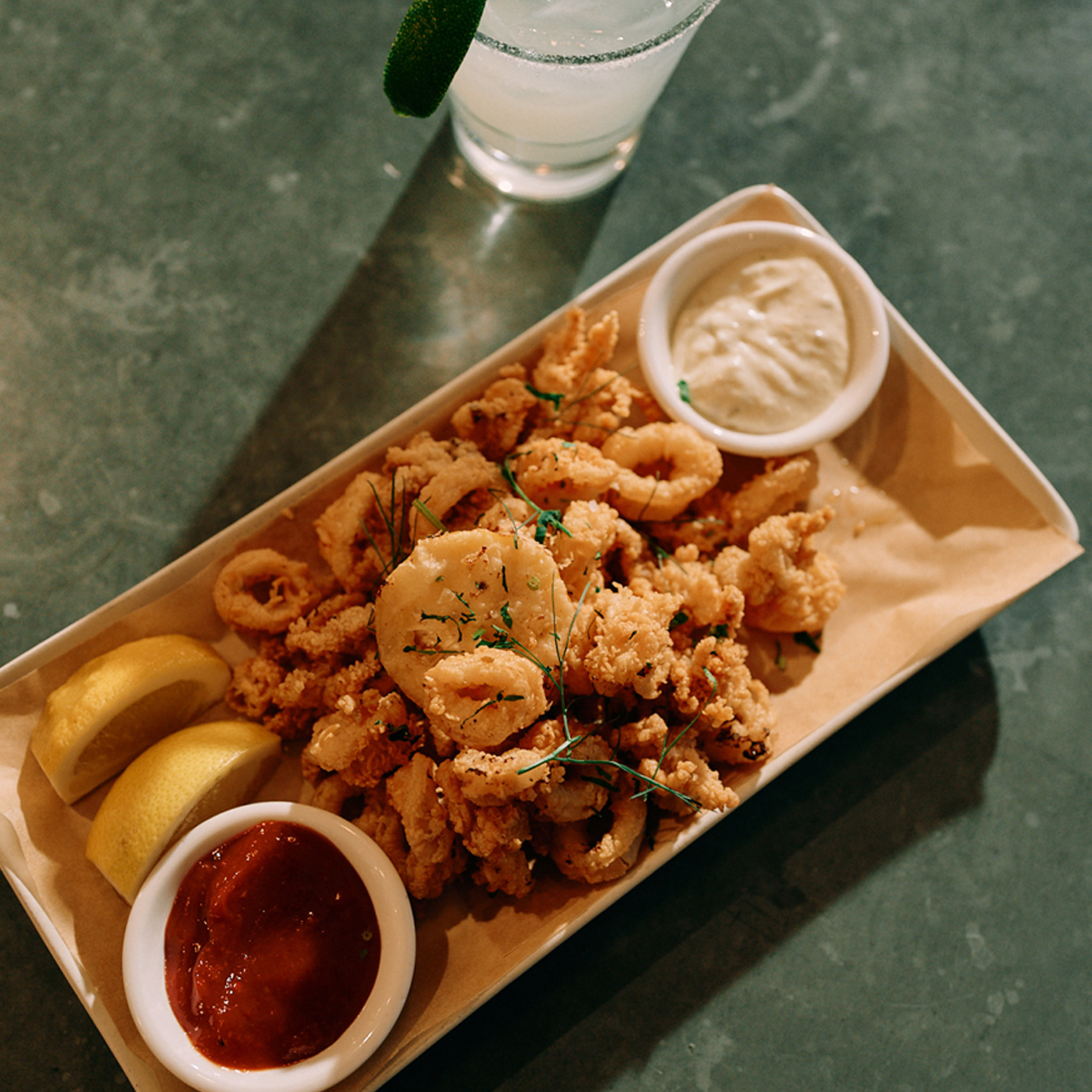 Fried calamari with sauces and cocktail.