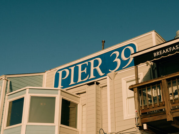 Pier 39 sign on waterfront building.
