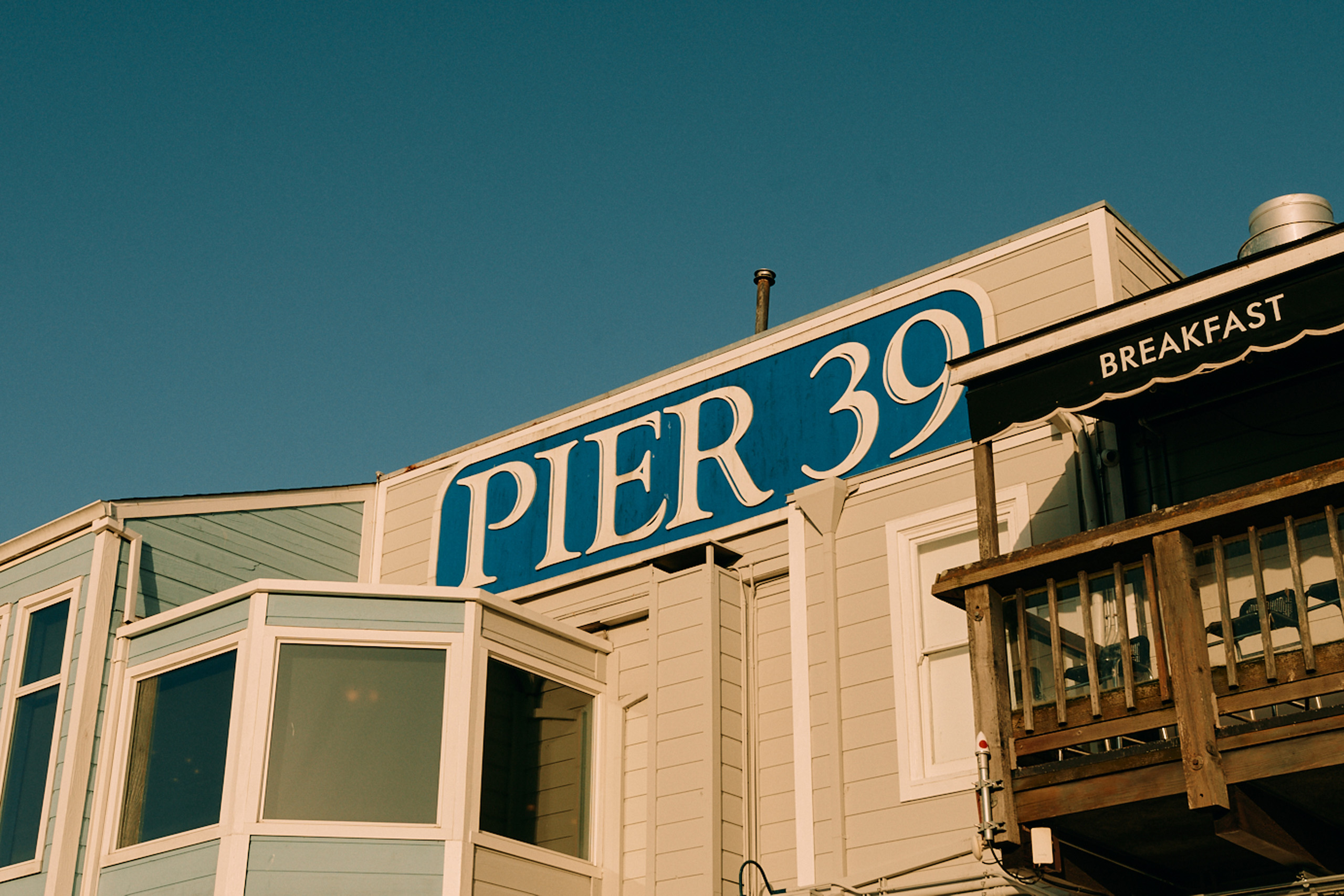 Pier 39 sign on waterfront building.