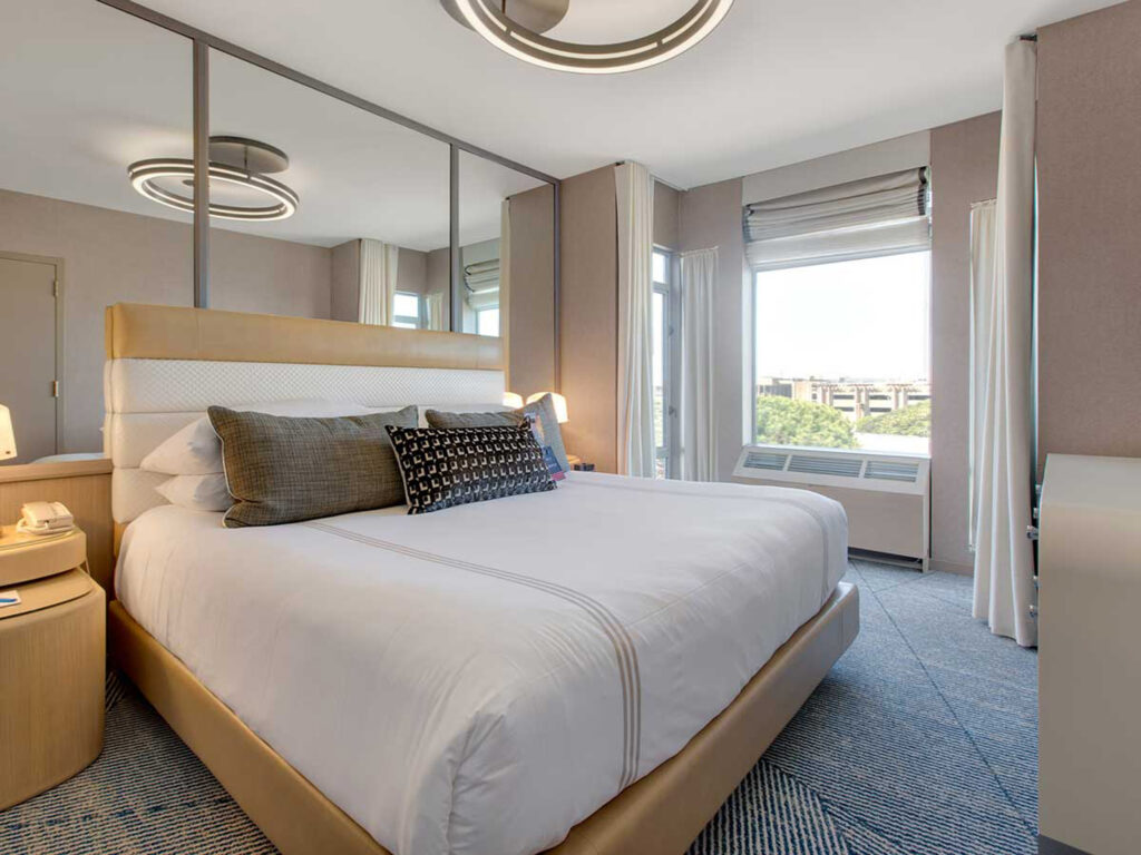 Accessible king room with large windows and modern decor.