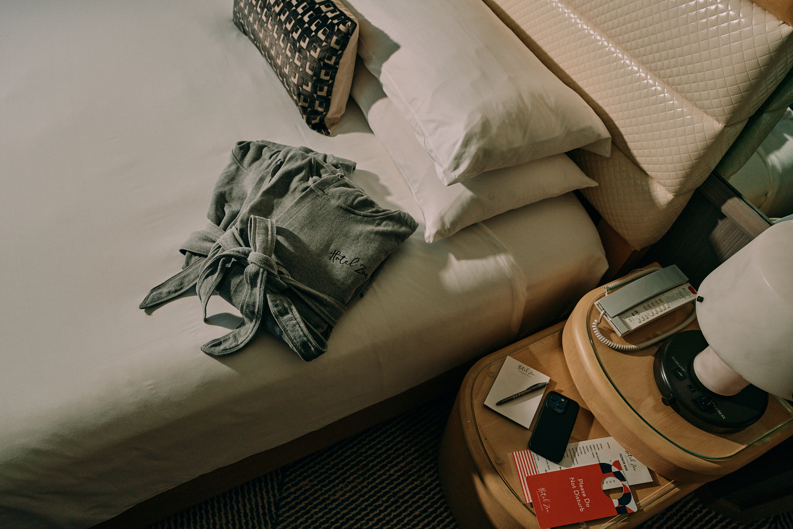 Hotel Zoe robe neatly placed on guest bed.