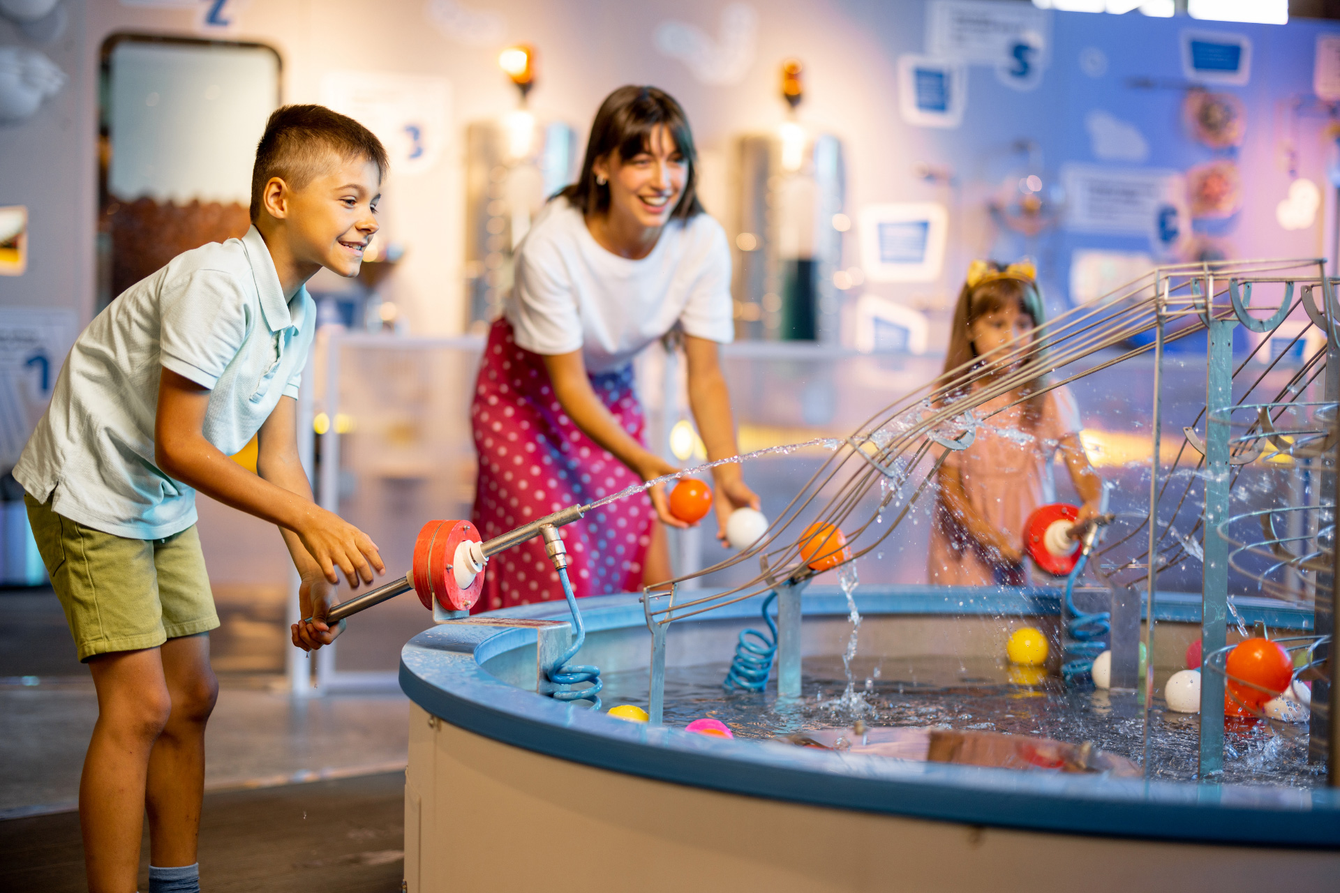 Children playing at interactive water exhibit indoors
