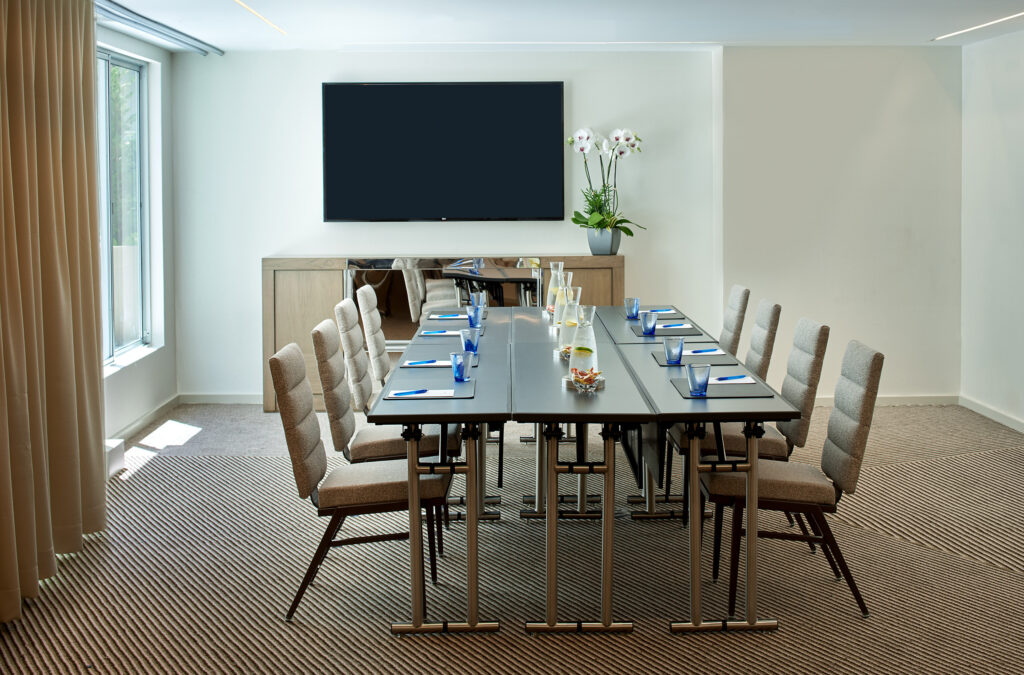 Bright meeting room with long conference table.