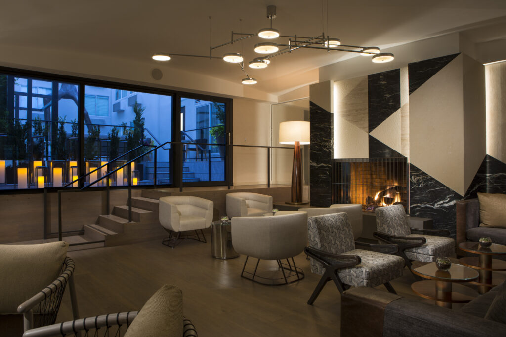 Modern hotel lobby with fireplace and contemporary seating.