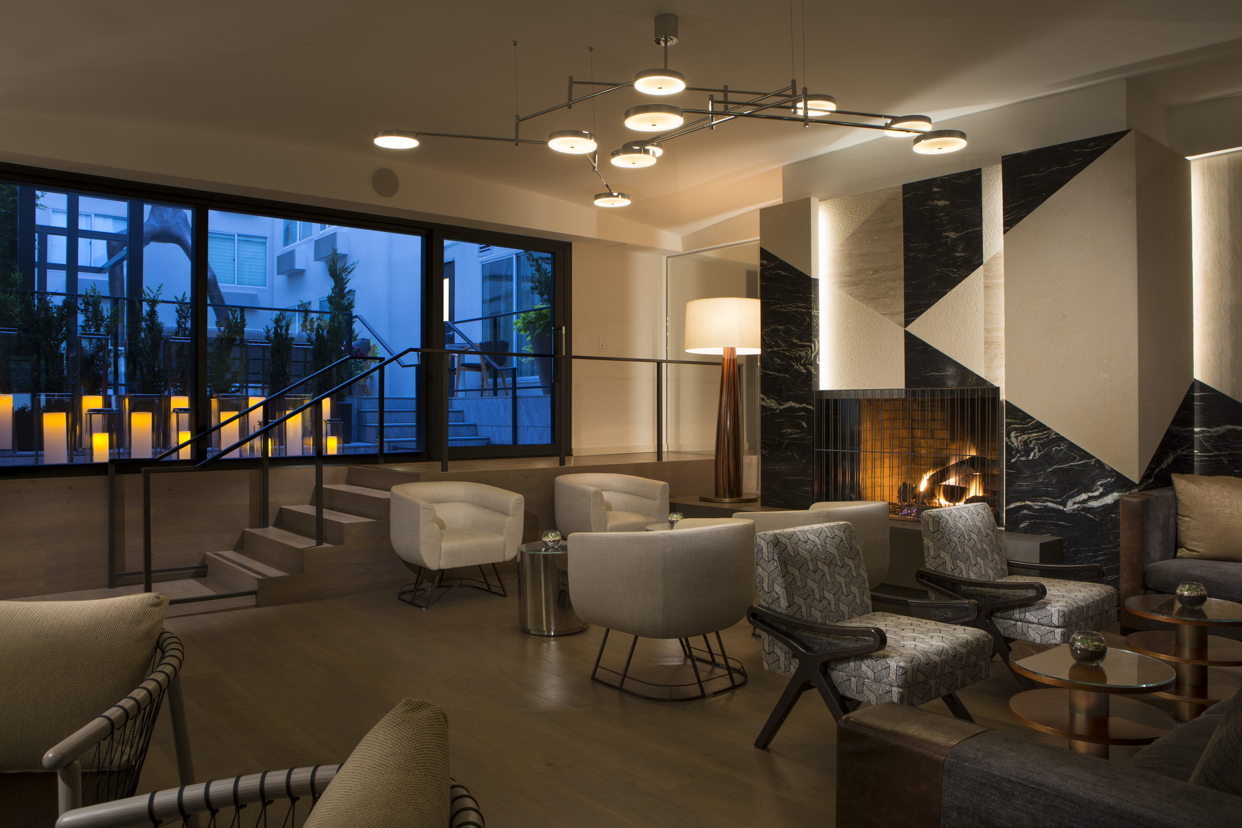 Modern hotel lobby with fireplace and contemporary seating.
