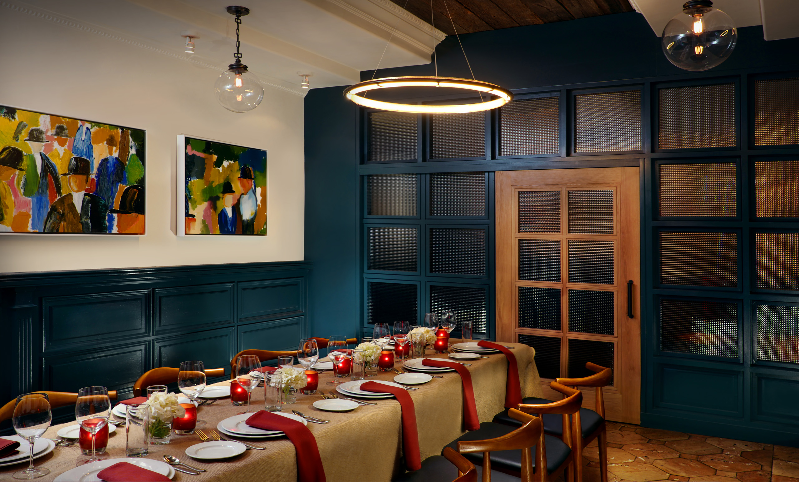 Elegant private dining room with long table set for guests.