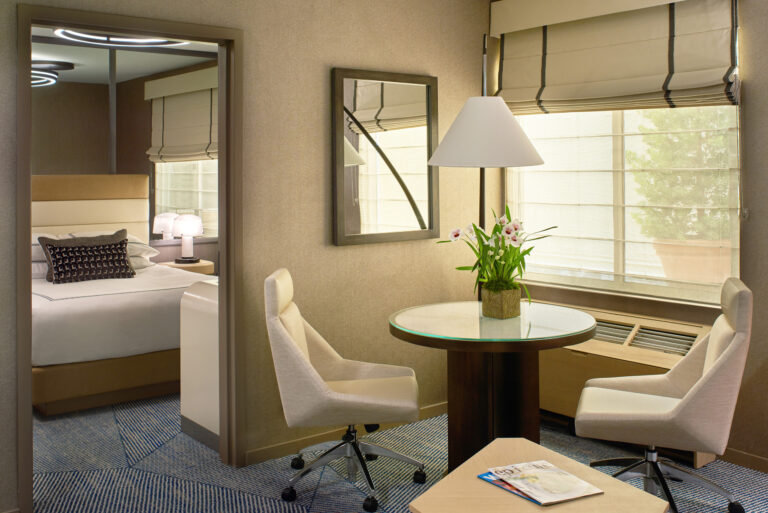 Dining table and chairs beside bedroom doorway