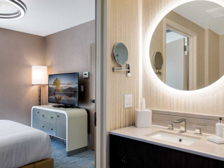 Bathroom vanity and bedroom TV view