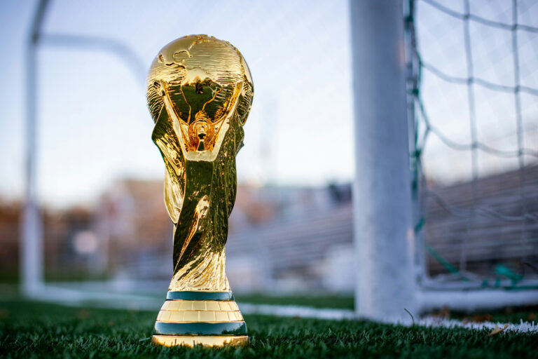 FIFA World Cup trophy displayed on a soccer field