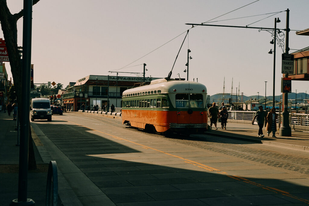 Historic streetcar along San Francisco waterfront promenade.