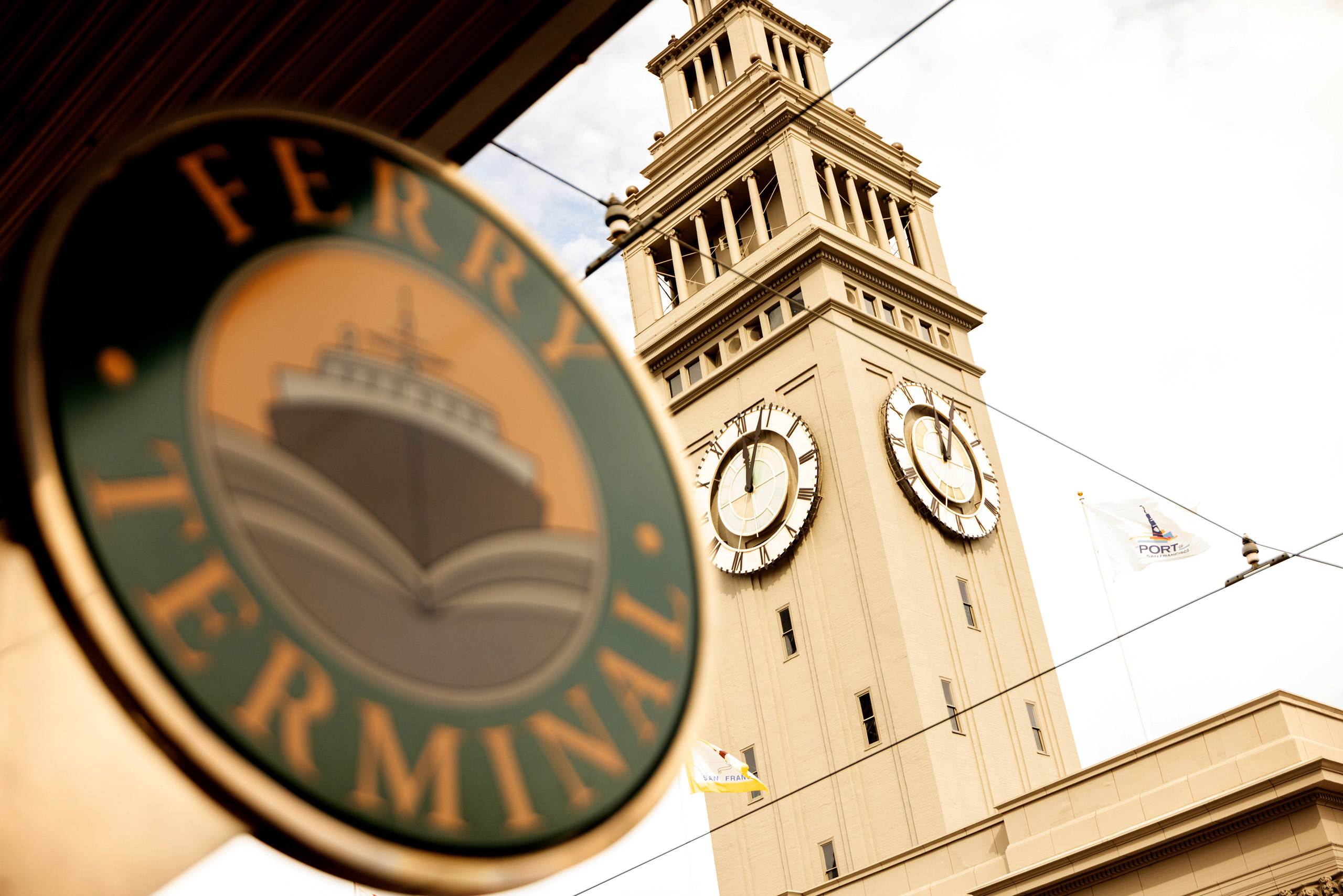 Ferry Terminal sign with iconic clocktower in soft daylight.