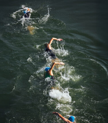 Swimmers racing through open water near San Francisco
