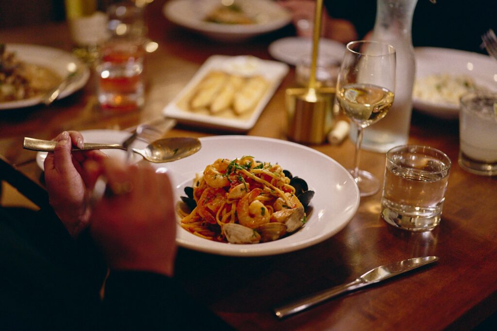 Seafood pasta served with wine and drinks
