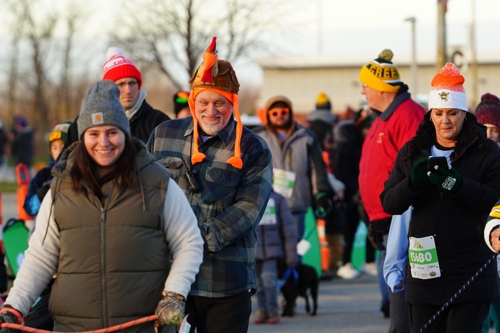 group of people walking with turkey head gear